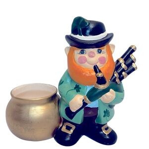 Charming Leprechaun Playing Bagpipes Standing Next to a Gold Pot Planter.